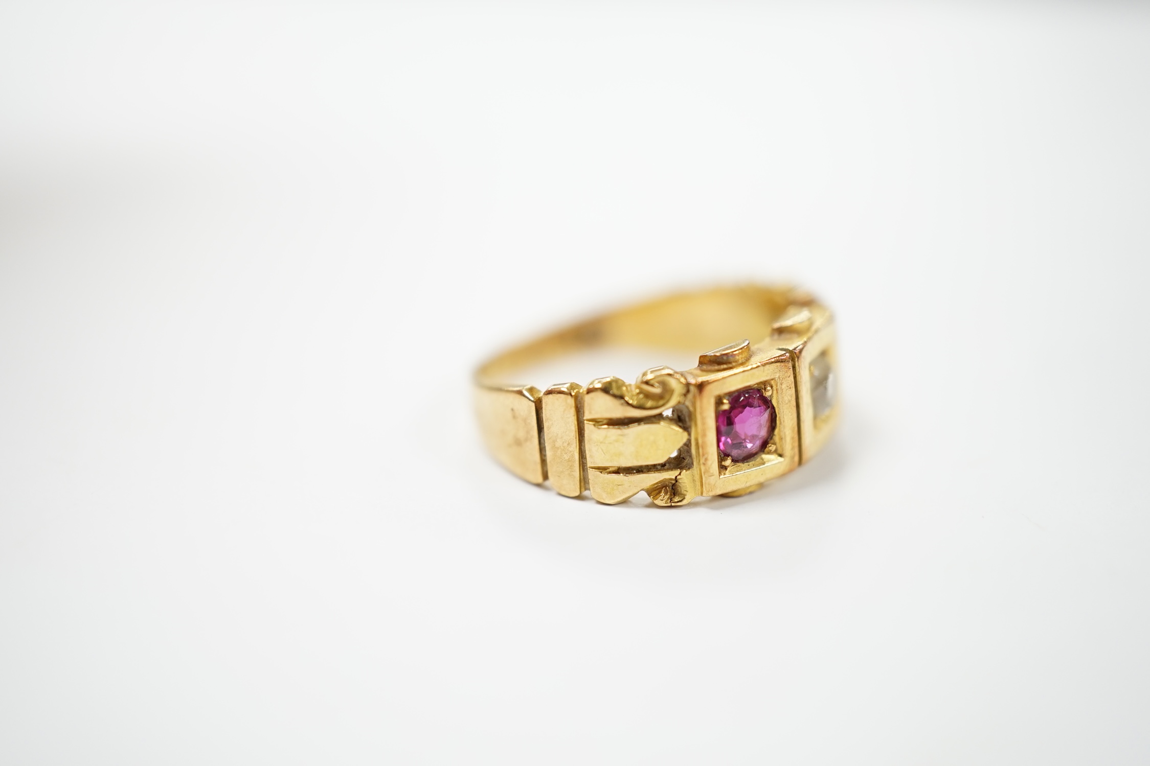 A late Victorian 18ct gold, ruby and diamond set three stone ring, size J, gross weight 4 grams. Condition - fair